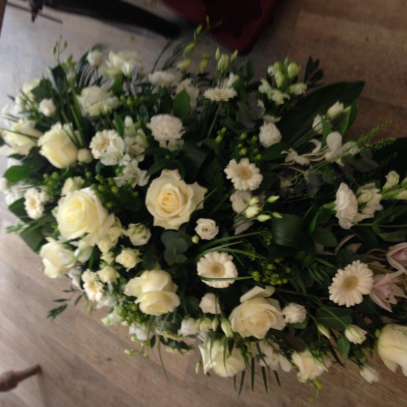 Classic whites casket spray.